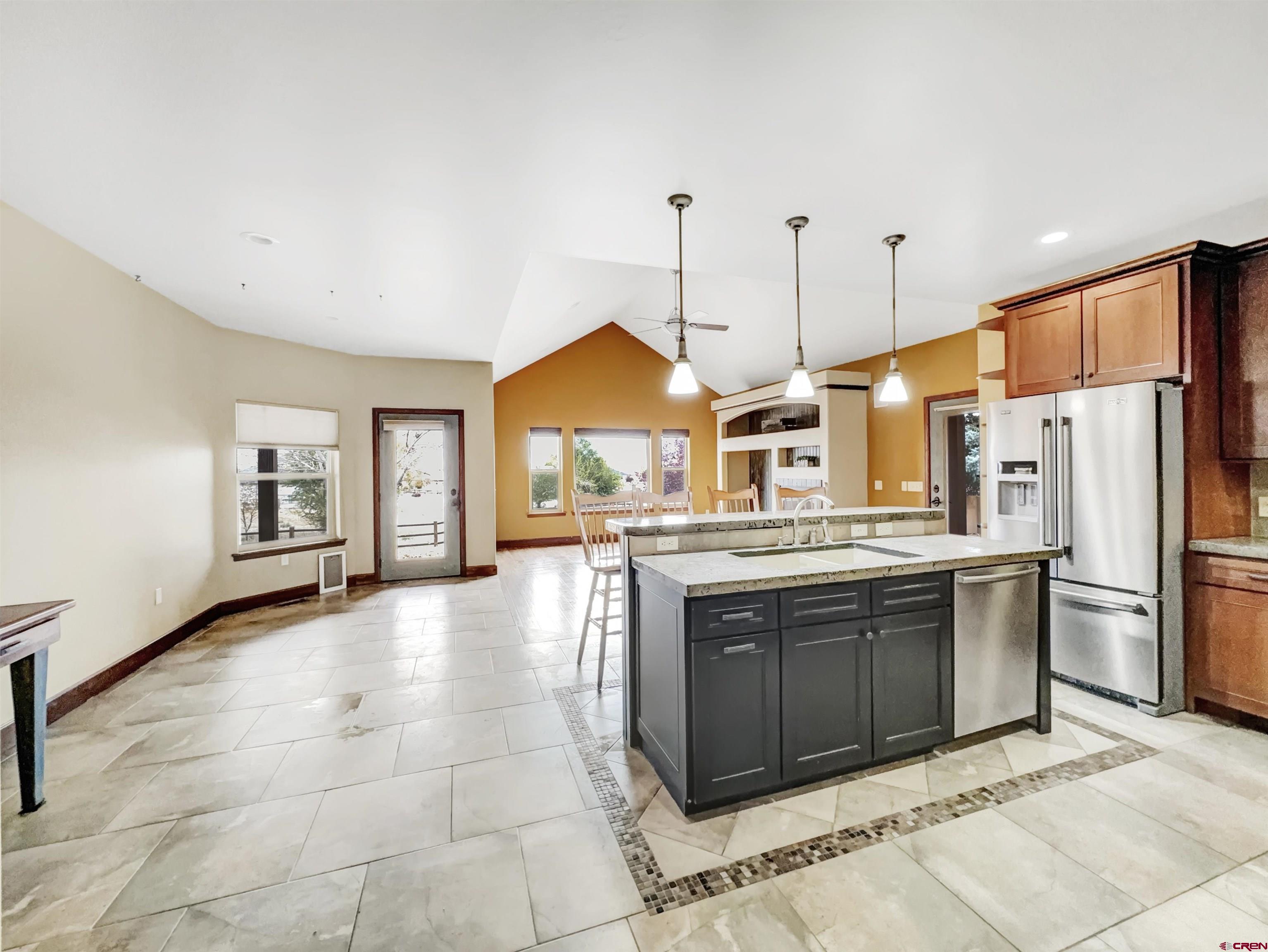 1794 Roubideau Street Delta, CO 81416 - Photo 3 of 35 a kitchen with stainless steel appliances granite countertop a stove a sink and a refrigerator