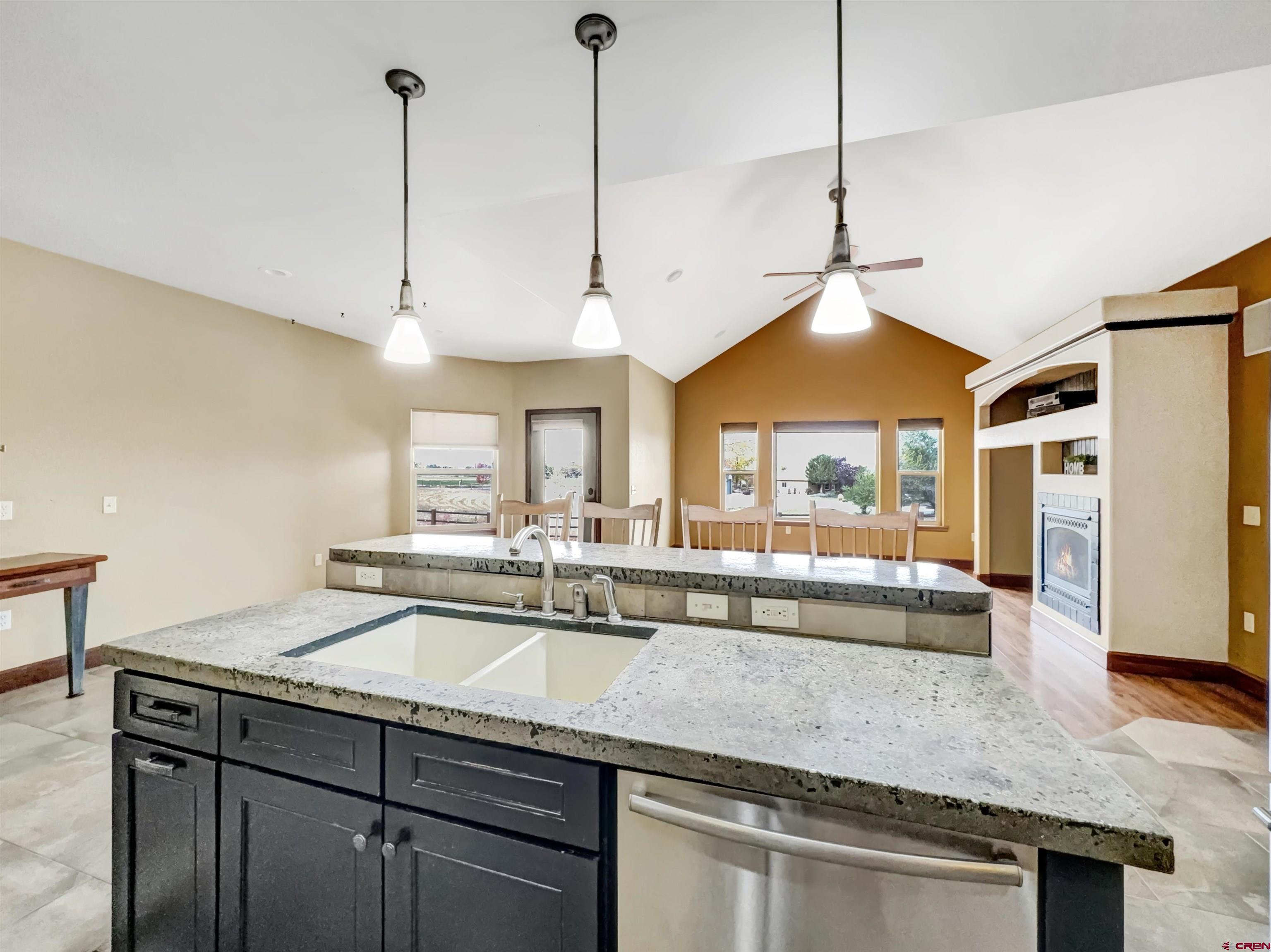 1794 Roubideau Street Delta, CO 81416 - Photo 6 of 35 a kitchen with stainless steel appliances granite countertop a sink a window and chairs