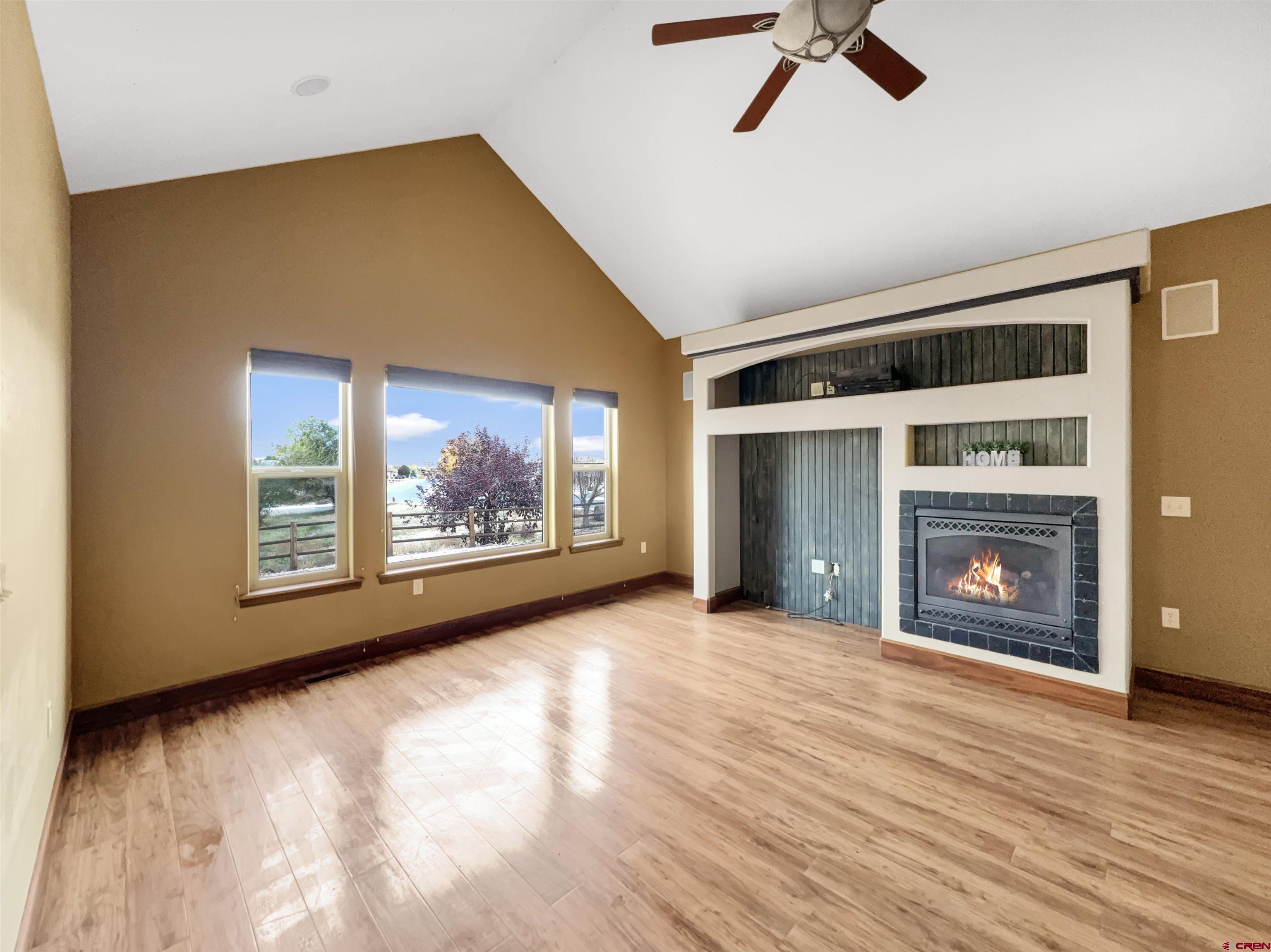 1794 Roubideau Street Delta, CO 81416 - Photo 8 of 35 a view of an empty room with a fireplace and a window