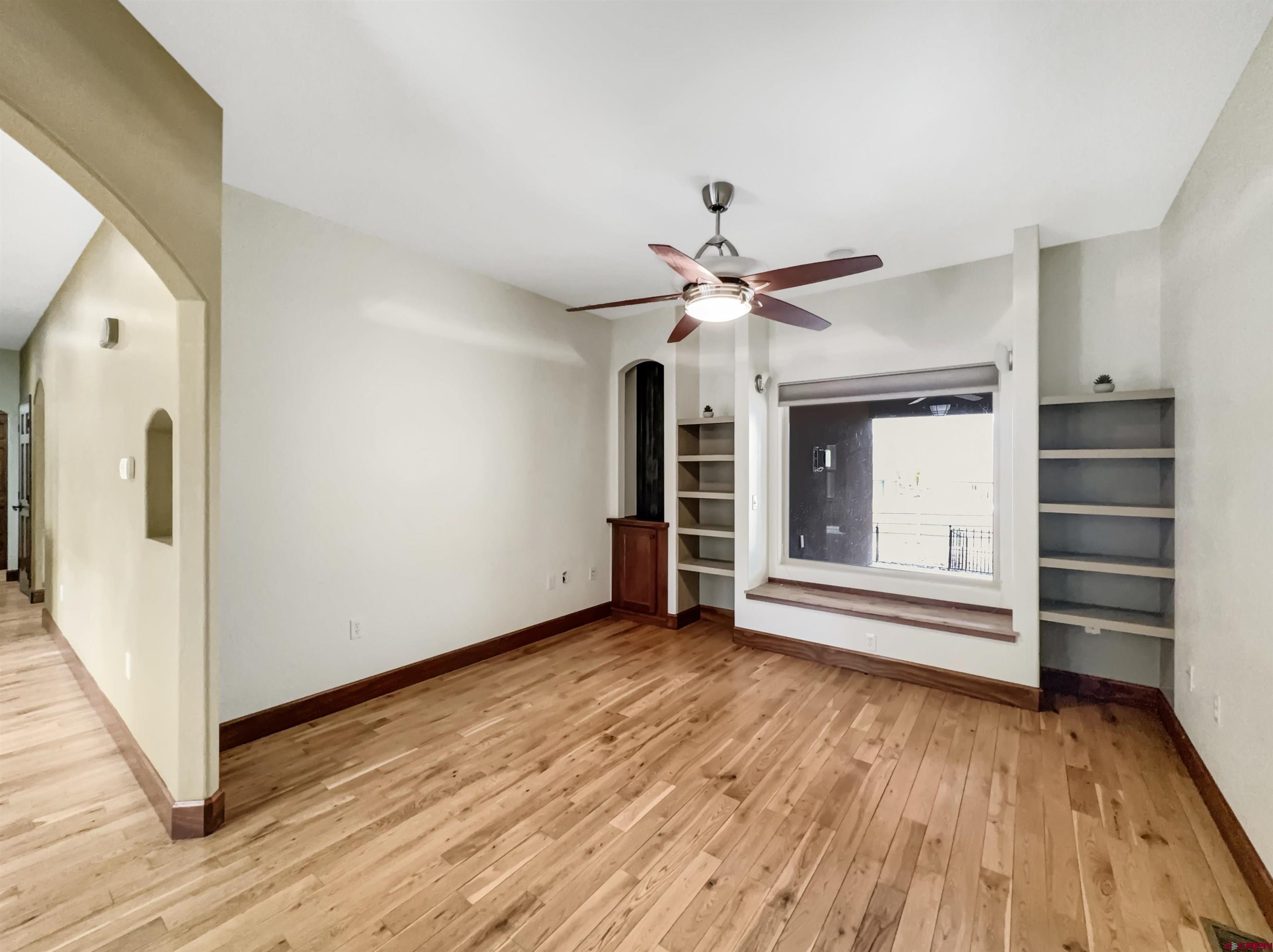 1794 Roubideau Street Delta, CO 81416 - Photo 9 of 35 wooden floor in an empty room with a window