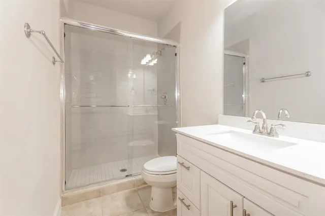 a bathroom with a double vanity sink a mirror and a shower
