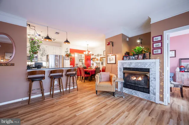 a living room with furniture a fireplace and a table