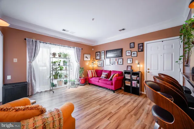 a bedroom with furniture and a wooden floor