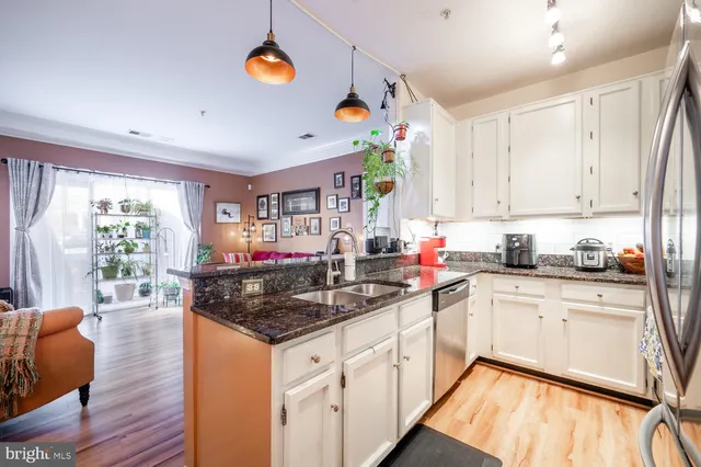 a kitchen with stainless steel appliances granite countertop a stove sink and cabinets