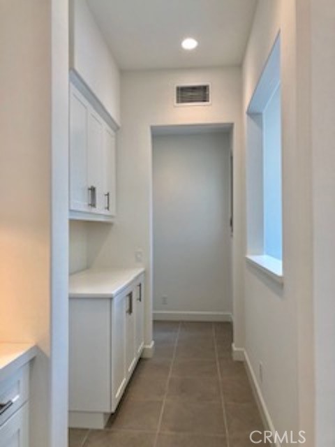 67 Tundra Irvine, CA 92602 - Photo 11 of 30 a view of a kitchen with white cabinets