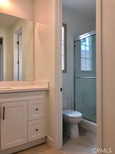 67 Tundra Irvine, CA 92602 - Photo 13 of 30 a bathroom with a toilet a sink and mirror