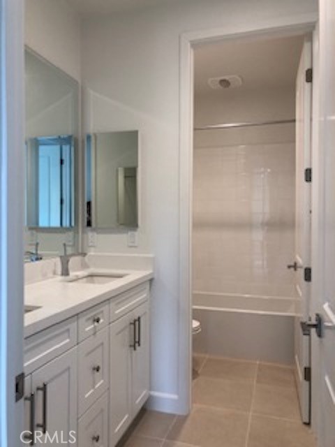 67 Tundra Irvine, CA 92602 - Photo 17 of 30 a bathroom with a shower sink vanity and mirror