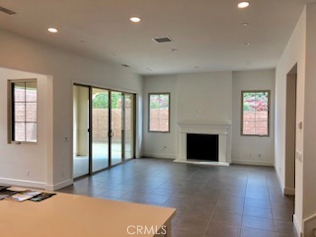 67 Tundra Irvine, CA 92602 - Photo 8 of 30 wooden floor fireplace and windows in an empty room