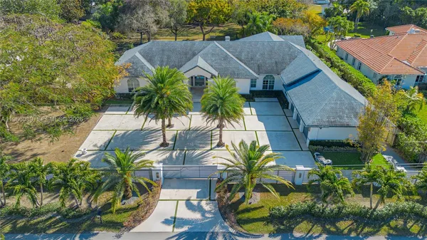 an aerial view of house with yard and outdoor seating