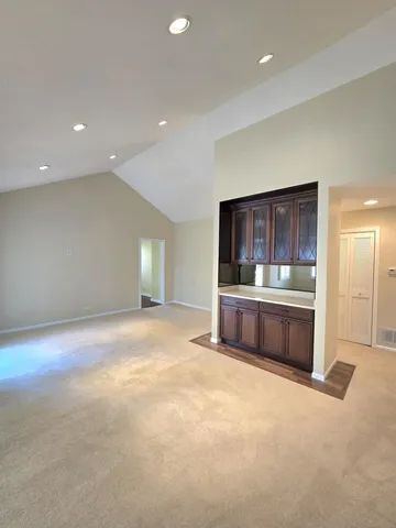 a view of an empty room with a kitchen