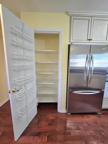 a view of walk in closet with empty racks