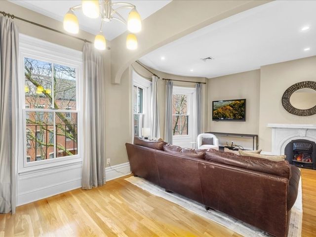 a living room with a bed furniture and a window