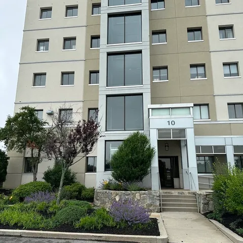 a front view of a building with a garden