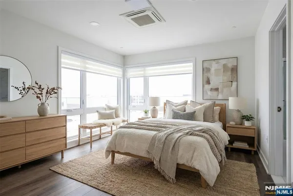 a bedroom with a bed and a large window