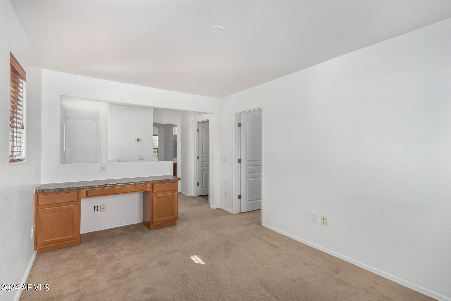 451 South Hawes Road, Unit 68 Mesa, AZ 85208 - Photo 11 of 30 an empty room with a sink and a mirror