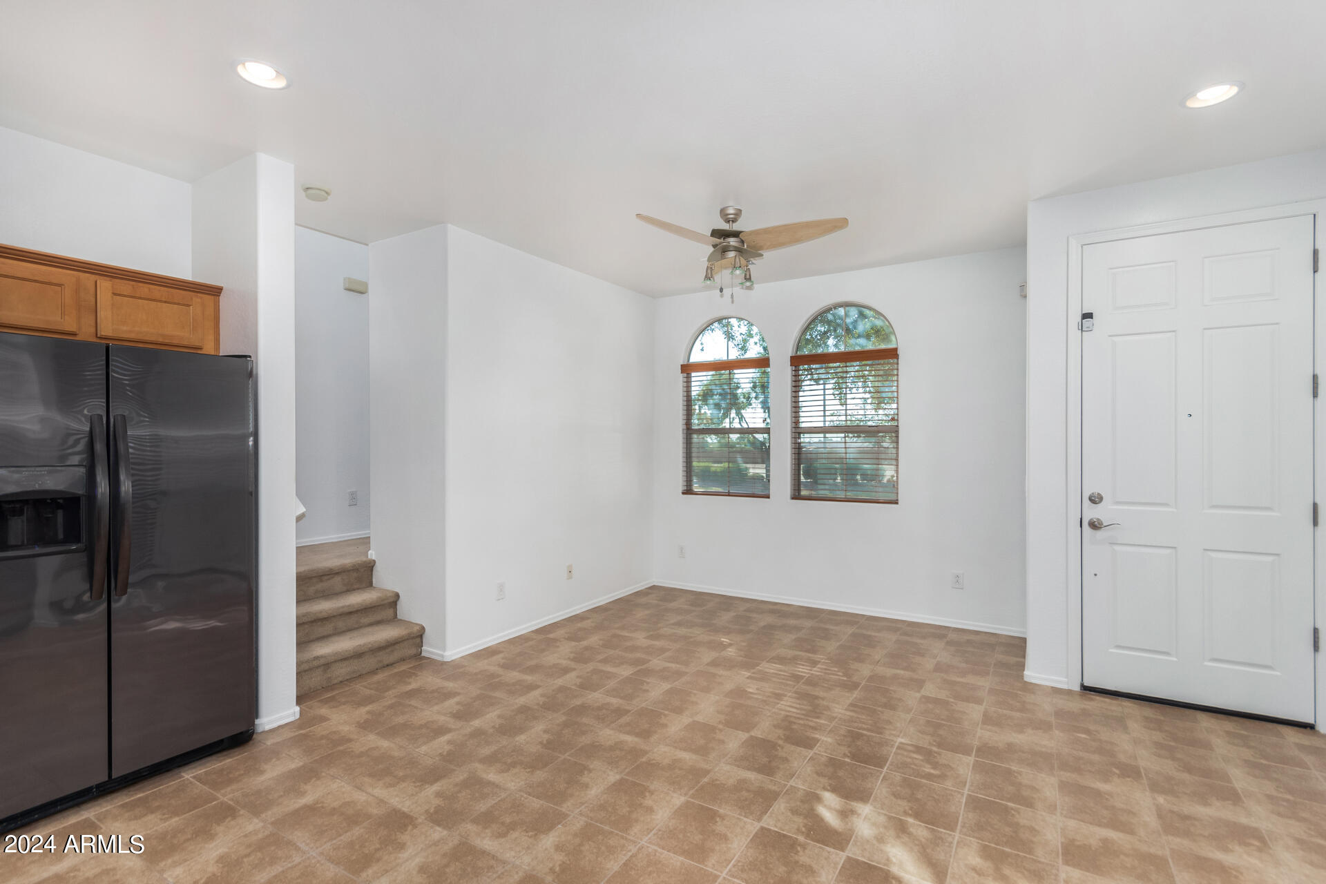 451 South Hawes Road, Unit 68 Mesa, AZ 85208 - Photo 5 of 30 an empty room with windows and chandelier fan