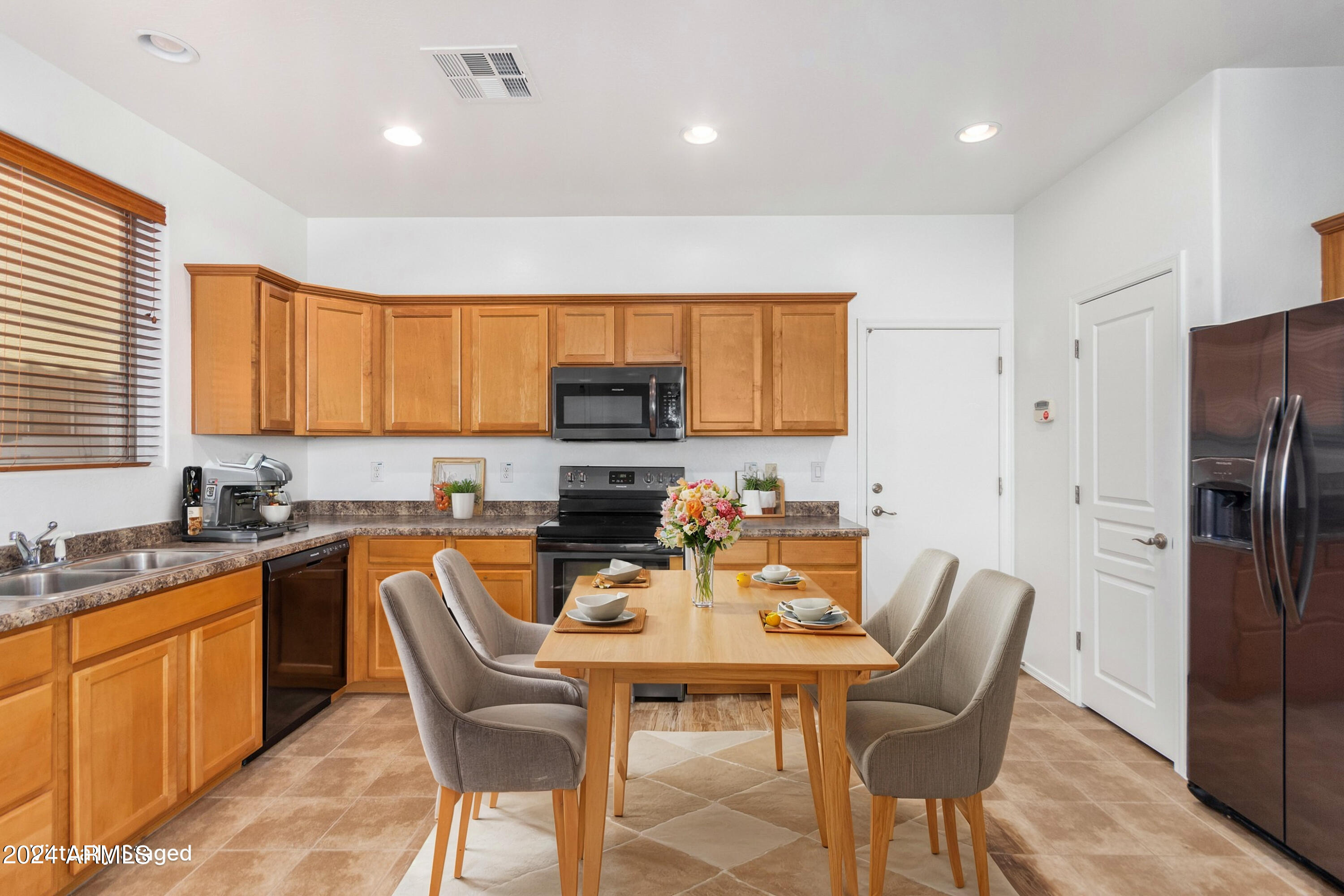 451 South Hawes Road, Unit 68 Mesa, AZ 85208 - Photo 7 of 30 a view of a kitchen with a dining table and chairs
