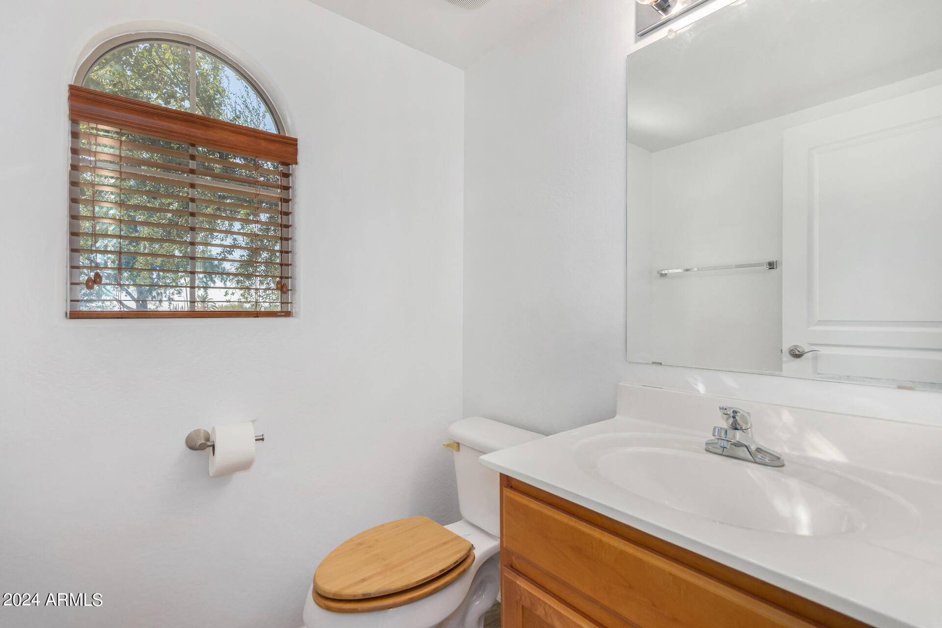 451 South Hawes Road, Unit 68 Mesa, AZ 85208 - Photo 10 of 30 a bathroom with a sink a toilet and a mirror