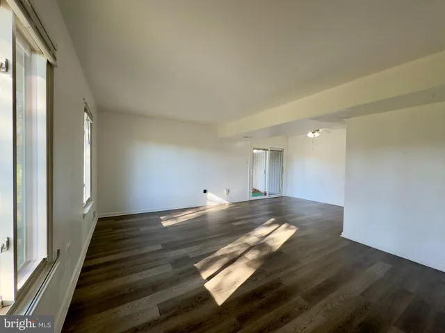 a view of wooden floor and windows in a room