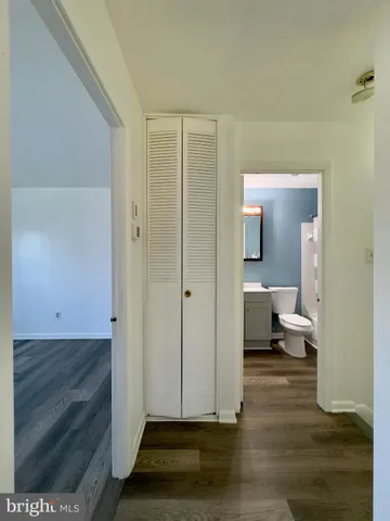 a view of a bathroom with toilet shower and a mirror