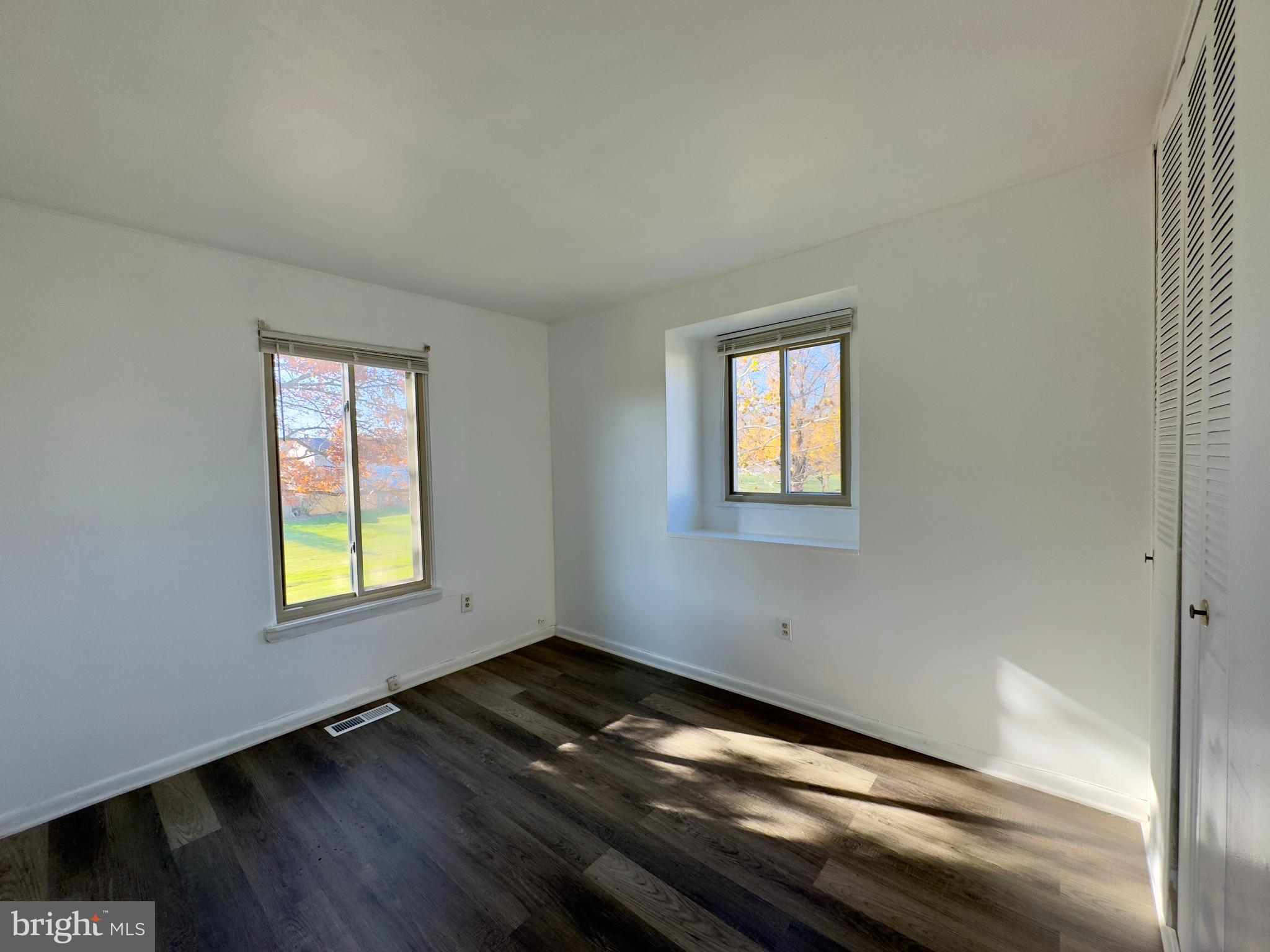 8 King Henry Circle Baltimore, MD 21237 - Photo 9 of 10 a view of an empty room with wooden floor and a window