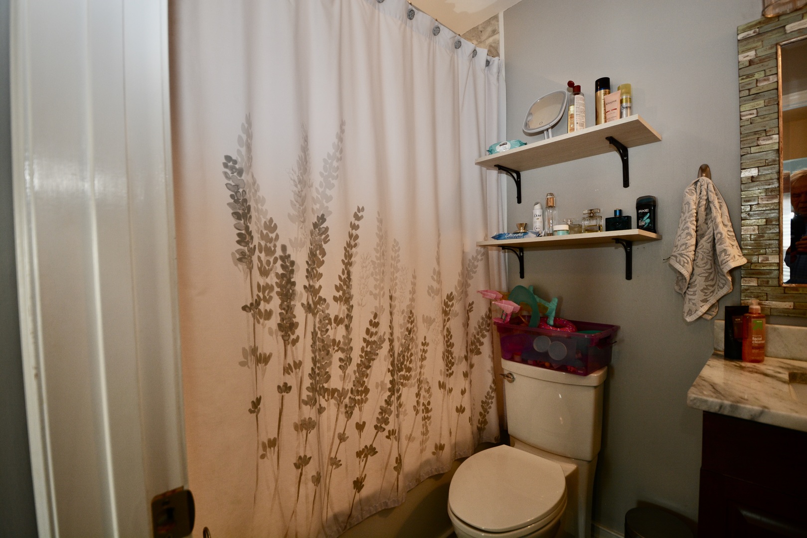 1699 Kautz Road Aurora, IL 60504 - Photo 11 of 19 a bathroom with a toilet and a shower curtain