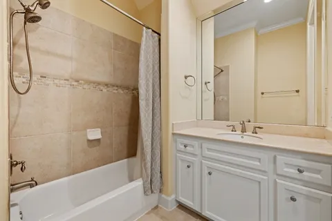a bathroom with a granite countertop sink a mirror and a bathtub
