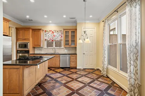 a kitchen with granite countertop a stove and a refrigerator