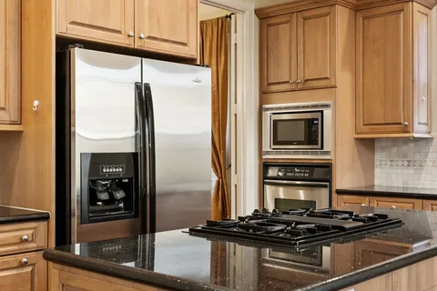 a kitchen with stainless steel appliances a refrigerator and a stove