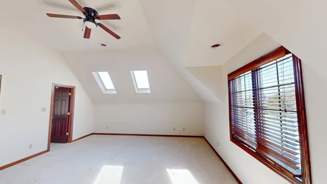 a view of a patio with chairs and a table under an umbrella