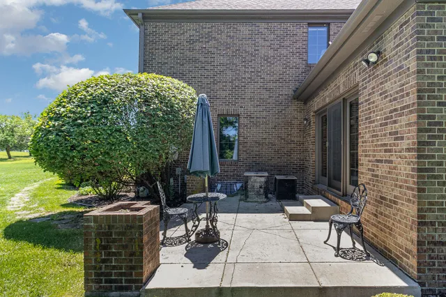 an aerial view of a house with a garden and trees
