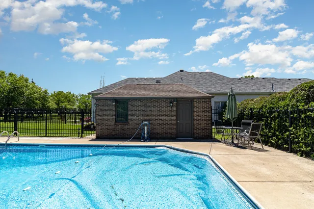 an aerial view of swimming pool a yard and green space