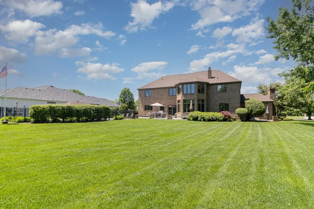 an aerial view of residential houses with outdoor space and trees
