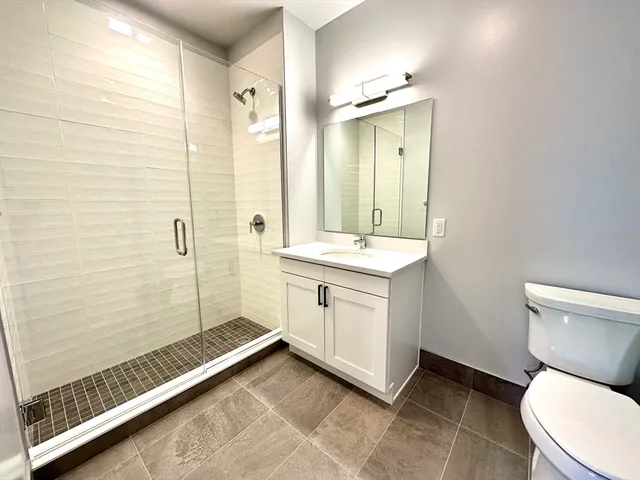 a bathroom with a toilet sink and shower