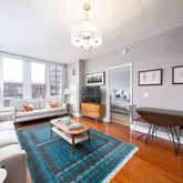 a living room with furniture a table and a large window