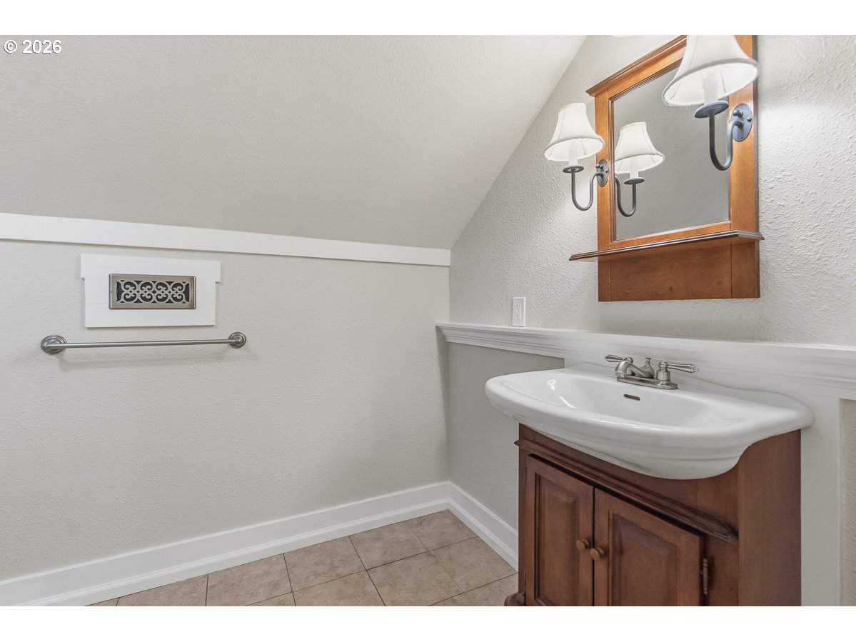16042 Southwest Waxwing Way Beaverton, OR 97007 - Photo 38 of 48 a bathroom with a sink and a mirror