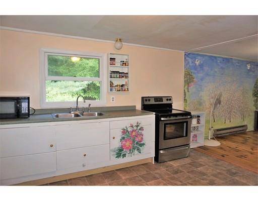 54 Breakneck Road Sturbridge, MA 01566 - Photo 8 of 35 a kitchen with stainless steel appliances a stove a sink and a refrigerator