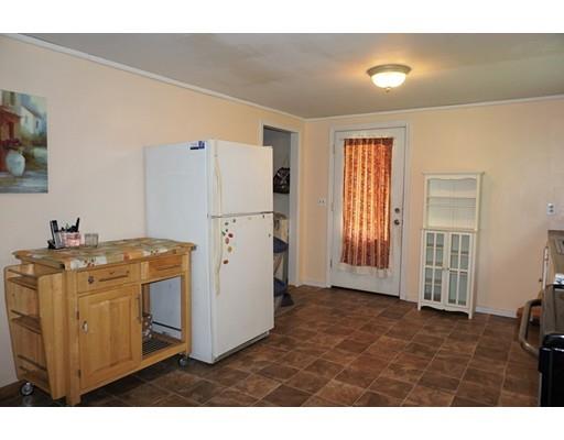 54 Breakneck Road Sturbridge, MA 01566 - Photo 10 of 35 a kitchen with cabinets and wooden floor