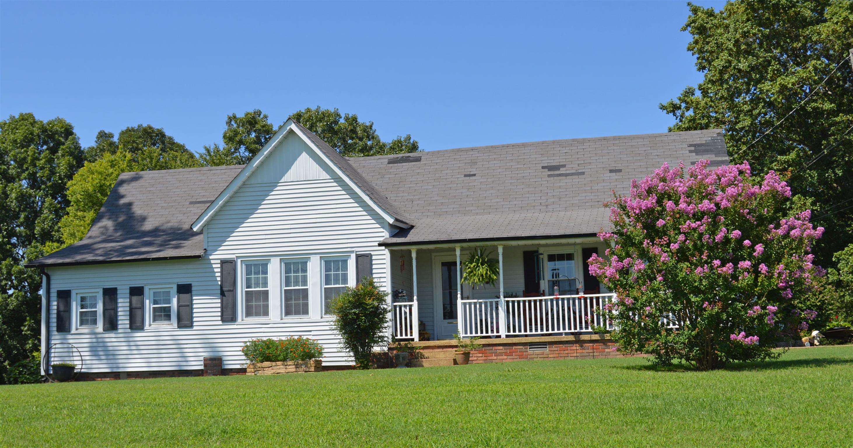 1434 Old Stewart Road Tennessee Ridge, TN 37178 - Photo 1 of 21 a front view of a house with a garden and yard