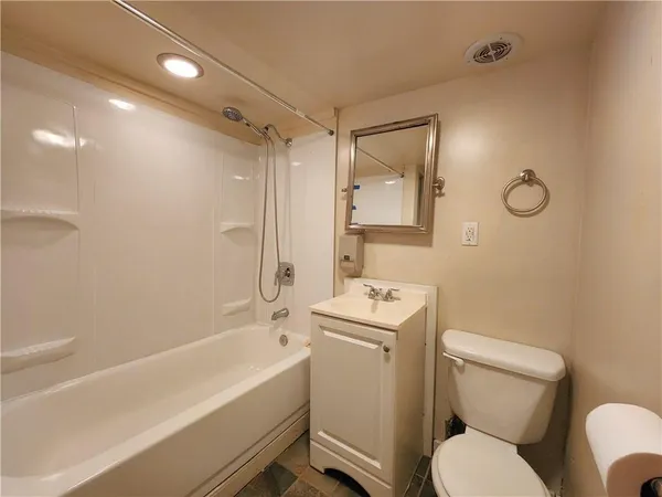 a bathroom with a toilet sink and shower