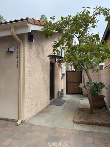 a view of a house with potted plants