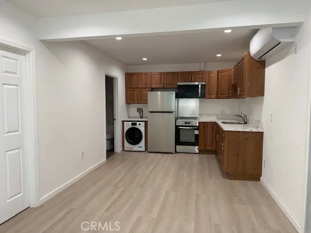 a kitchen with stainless steel appliances granite countertop a refrigerator sink and cabinets