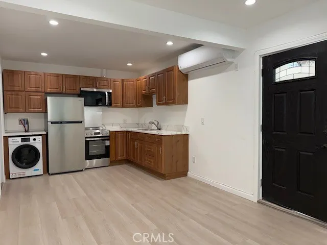 a kitchen with stainless steel appliances a refrigerator and a stove top oven