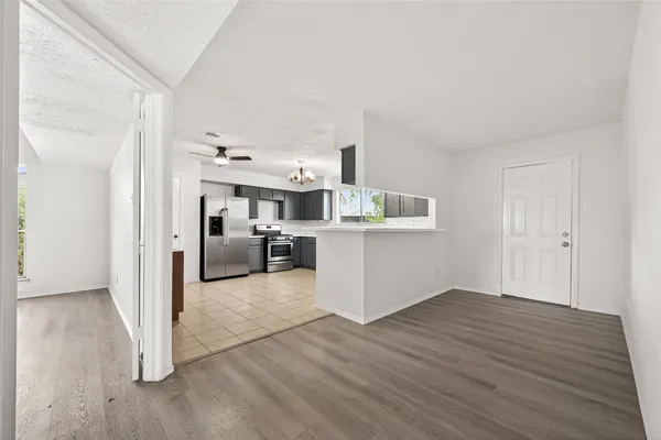a view of a kitchen with a sink and wooden floor