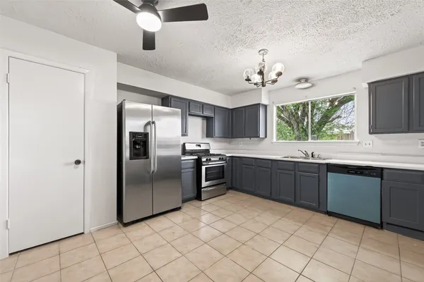 a kitchen with stainless steel appliances granite countertop a sink and cabinets