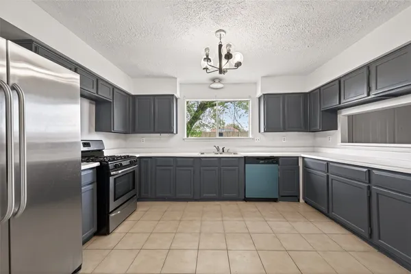 a kitchen with a sink stove and microwave