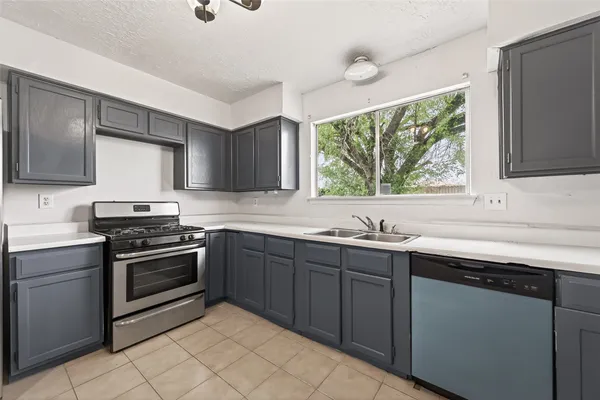 a kitchen with a sink stove and cabinets
