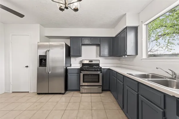 a kitchen with a sink and large window
