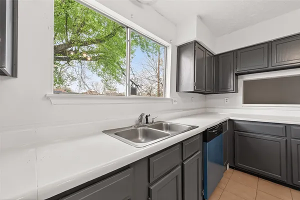 a stove top oven sitting inside of a kitchen
