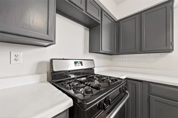 a room with a dresser and a ceiling fan